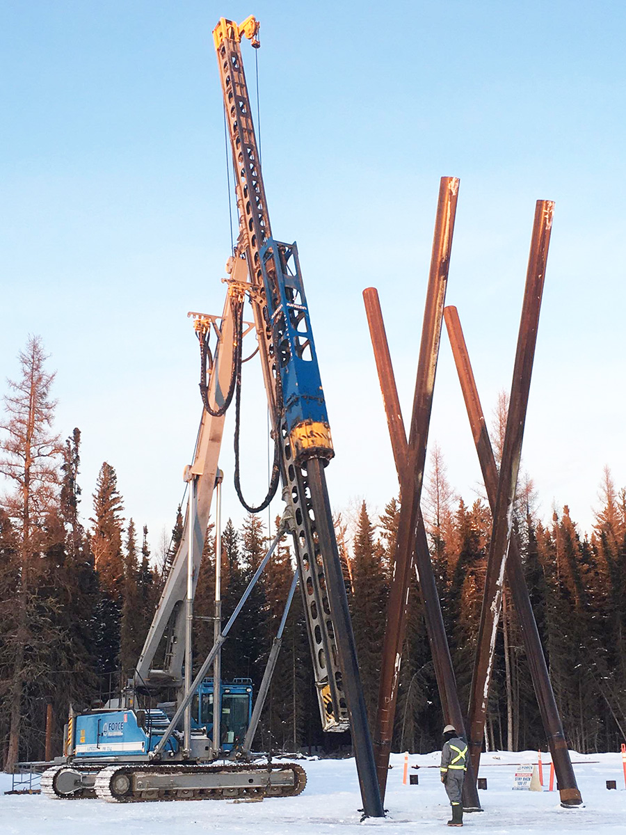 Junttan PM23 pile driving rig piling battered piles by Force Pile Driving in Northern Alberta, Canada.